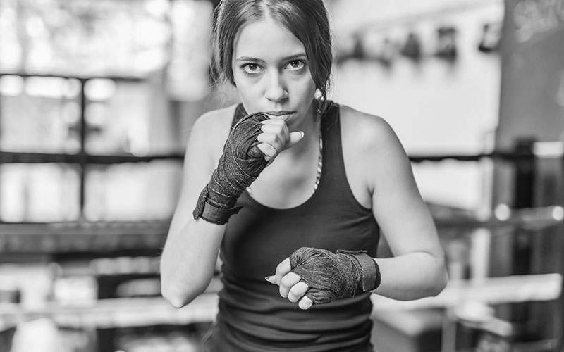 K1 mixed martial arts, Hispanic young woman fighter doing aerobox for cardio. Power strengh action